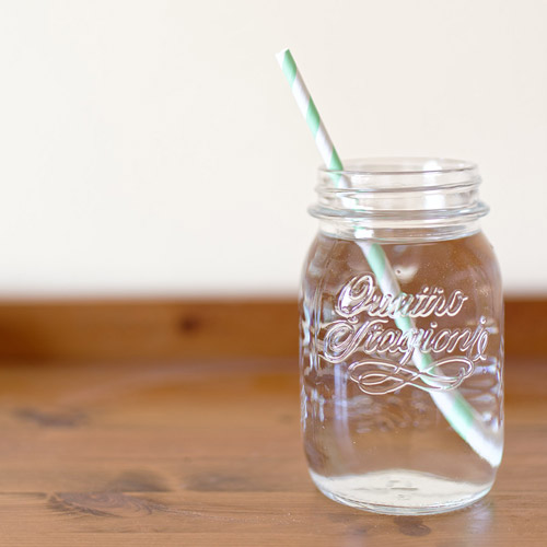 mason jar of pure water with a mint striped straw